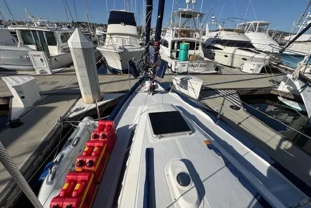 Slide: The Image of 1986 Fairweather Mariner 39 sailboat docked at marina, surrounded by other boats. - 36