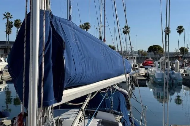 Slide: The Image of Sailboat docked in marina, Fairweather Mariner 39, 1986 model, with blue sail cover. - 39