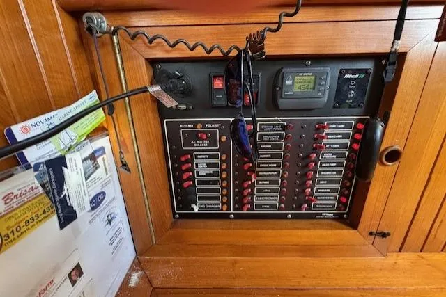 Slide: The Image of Electrical panel of 1986 Fairweather Mariner 39 boat with various switches and gauges. - 4