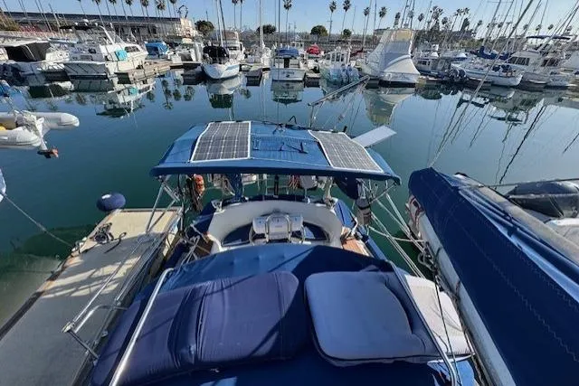 Slide: The Image of 1986 Fairweather Mariner 39 sailboat docked in a marina with solar panels on deck. - 40