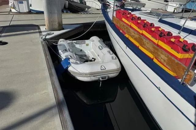 Slide: The Image of 1986 Fairweather Mariner 39 docked with inflatable dinghy alongside. - 43