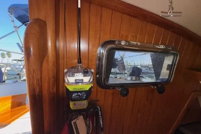 Slide: The Image of 1986 Fairweather Mariner 39 interior with wooden paneling and window view of marina. - 8