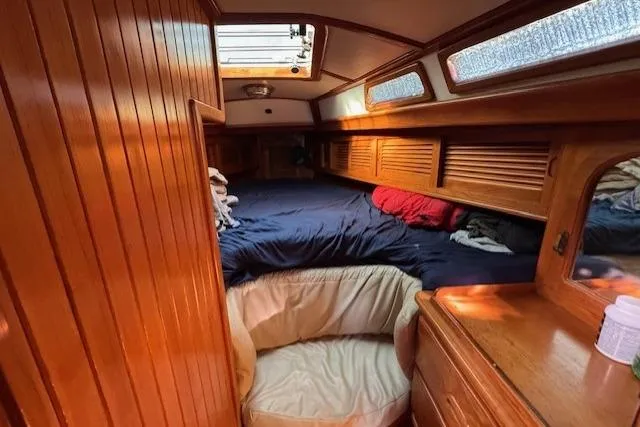 Slide: The Image of Cozy cabin interior of 1986 Fairweather Mariner 39 sailboat with wooden paneling and bedding. - 9