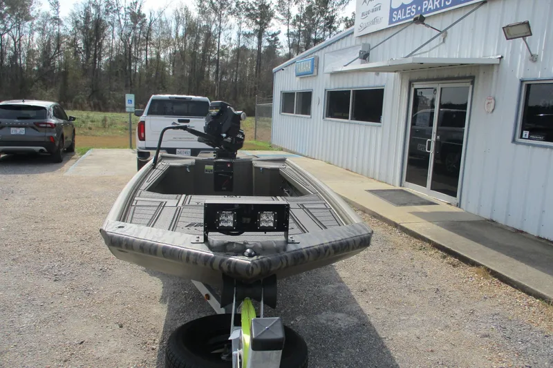 Slide: The Image of 2026 Gator Tail 1854 Extreme boat on trailer outside dealership. - 2