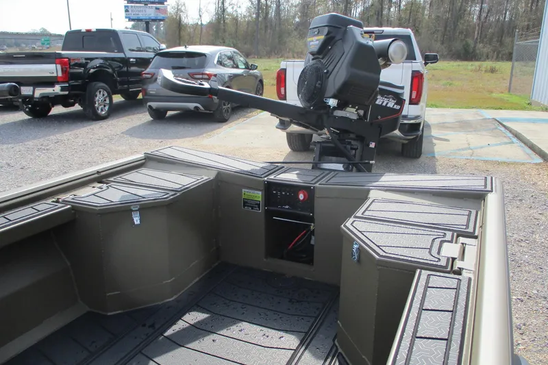 Slide: The Image of 2026 Gator Tail 1854 Extreme boat interior with motor, parked near vehicles. - 6