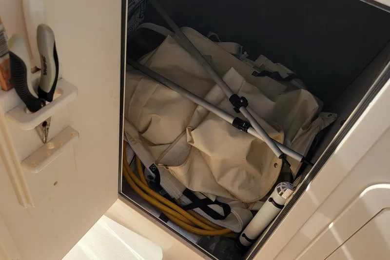 Slide: The Image of Storage compartment on a 2019 Grady-White Freedom 307 boat with tools and equipment. - 12
