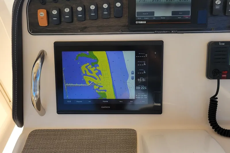 Slide: The Image of 2019 Grady-White Freedom 307 boat dashboard with Garmin navigation display. - 14