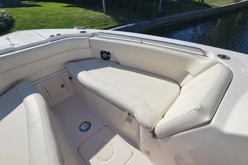 Slide: The Image of 2019 Grady-White Freedom 307 boat interior with white cushioned seating. - 17