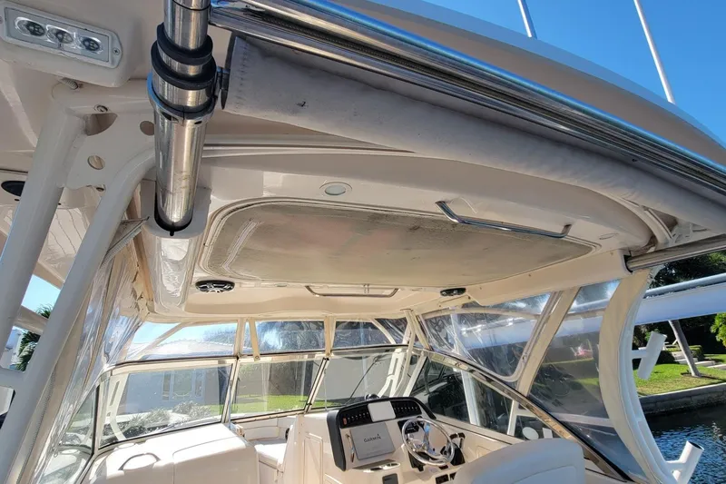 Slide: The Image of 2019 Grady-White Freedom 307 boat interior with helm and canopy view. - 20