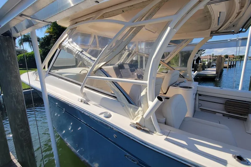 Slide: The Image of 2019 Grady-White Freedom 307 boat docked, featuring sleek design and comfortable seating. - 3