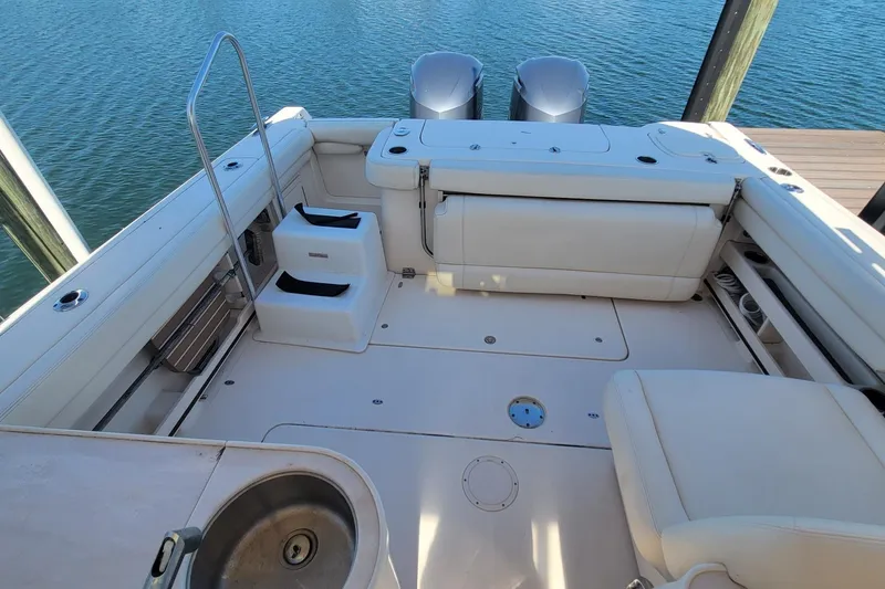 Slide: The Image of 2019 Grady-White Freedom 307 boat interior with seating and twin engines. - 4