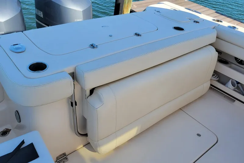 Slide: The Image of 2019 Grady-White Freedom 307 boat seating area with cup holders and storage. - 5