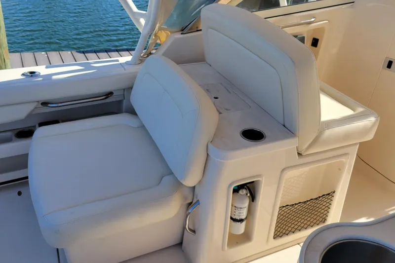 Slide: The Image of 2019 Grady-White Freedom 307 boat interior with white seating and storage compartments. - 6