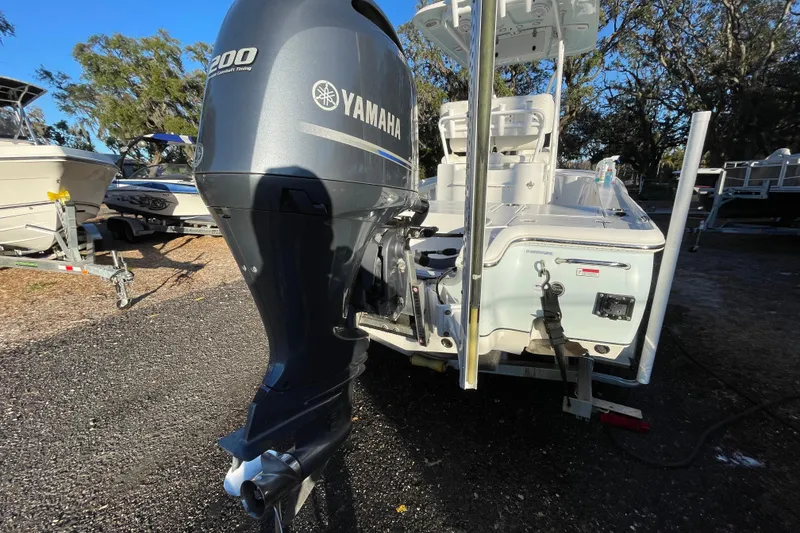 Slide: The Image of 2019 Sea Hunt BX 22 BR boat with Yamaha 200 engine, parked outdoors. - 2