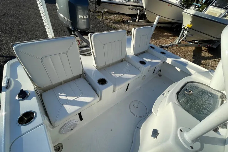 Slide: The Image of 2019 Sea Hunt BX 22 BR boat interior with three white seats and Yamaha 200 engine. - 4