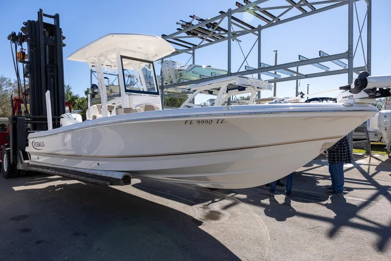 The Image of 2023 Robalo 246 Cayman boat on forklift, displayed outdoors. - 1
