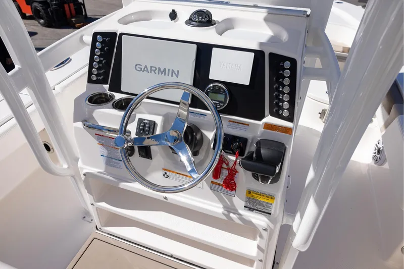 Slide: The Image of 2023 Robalo 246 Cayman boat dashboard with Garmin and Yamaha controls. - 12