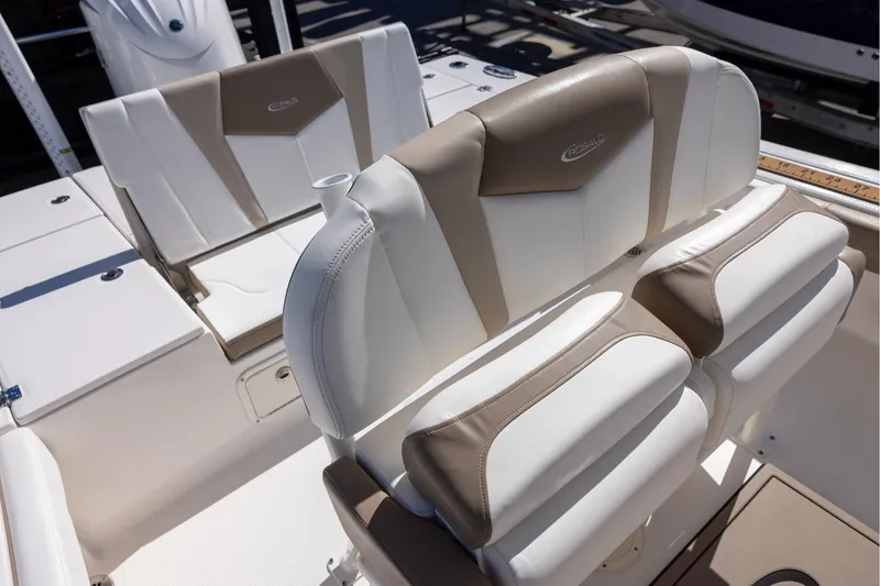 Slide: The Image of 2023 Robalo 246 Cayman boat seating with beige and white upholstery. - 13