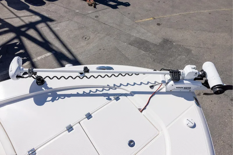 Slide: The Image of 2023 Robalo 246 Cayman boat with Minn Kota trolling motor on deck. - 19
