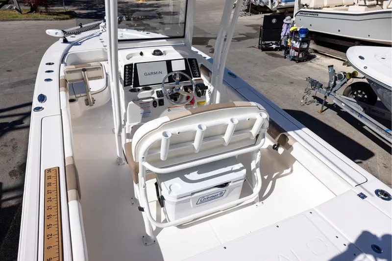 Slide: The Image of 2023 Robalo 246 Cayman boat interior with Garmin navigation system and seating. - 7