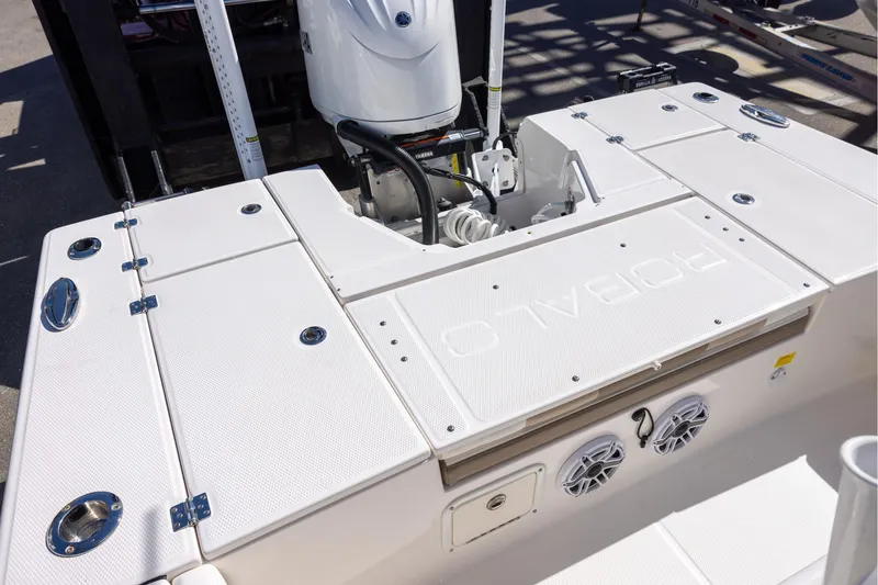Slide: The Image of 2023 Robalo 246 Cayman boat deck with Yamaha outboard motor and storage compartments. - 8