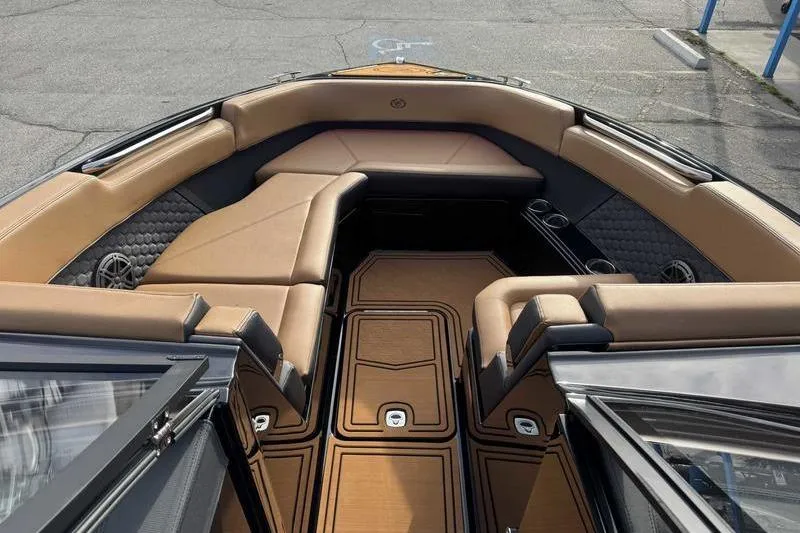 Slide: The Image of 2026 Cobalt R8 Surf boat interior with luxurious tan seating and sleek design. - 14