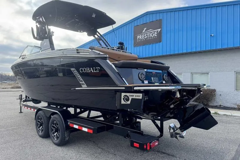 Slide: The Image of 2026 Cobalt R8 Surf boat on trailer at Prestige Water Sports dealership. - 4