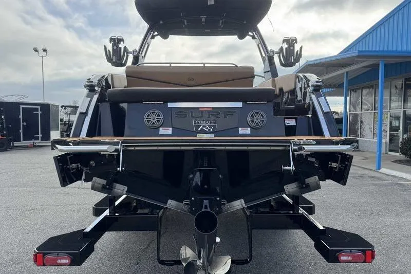 Slide: The Image of 2026 Cobalt R8 Surf boat rear view at a dealership, showcasing sleek design and features. - 5