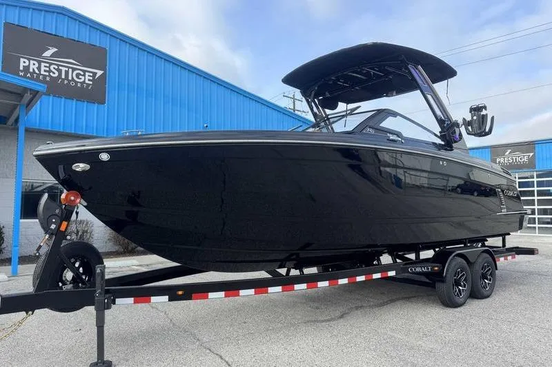 Slide: The Image of 2026 Cobalt R8 Surf boat on trailer at Prestige Water Sports dealership. - 9