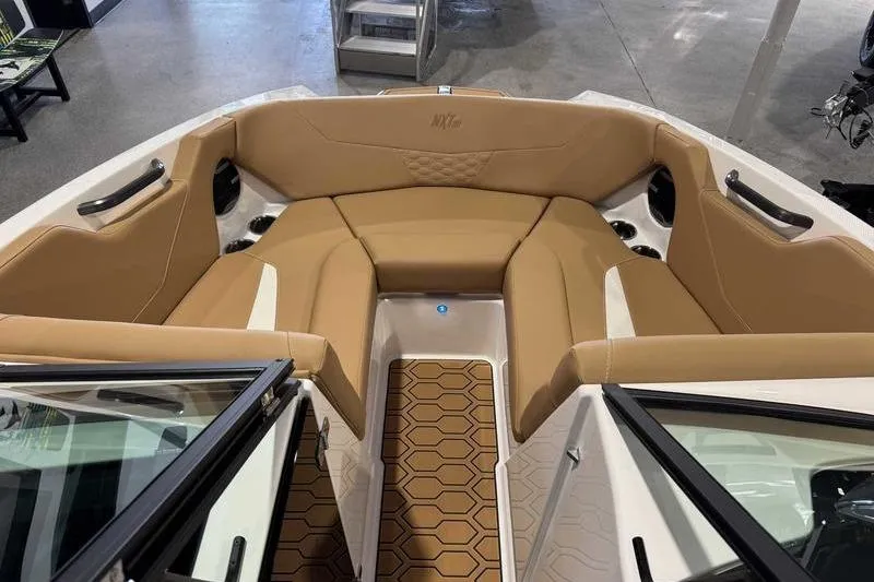 Slide: The Image of 2026 MasterCraft NXT20 boat interior with tan seating and hexagonal floor design. - 15