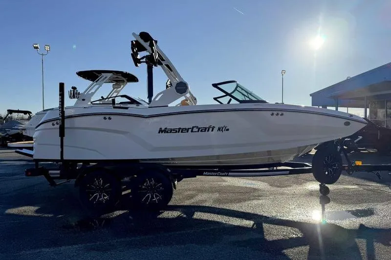 Slide: The Image of 2026 MasterCraft NXT20 boat on trailer in sunny outdoor setting. - 3