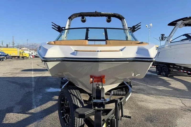 Slide: The Image of 2026 MasterCraft NXT20 boat on trailer, front view in outdoor setting. - 4