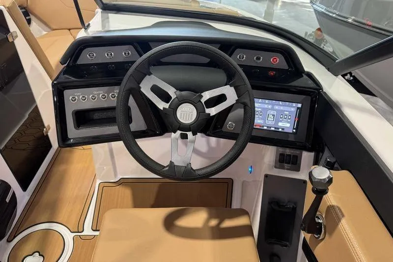 Slide: The Image of 2026 MasterCraft NXT20 boat dashboard with steering wheel and digital display. - 7
