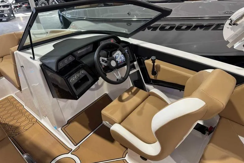 Slide: The Image of 2026 MasterCraft NXT20 boat interior with tan and white seating, modern dashboard, and steering wheel. - 8