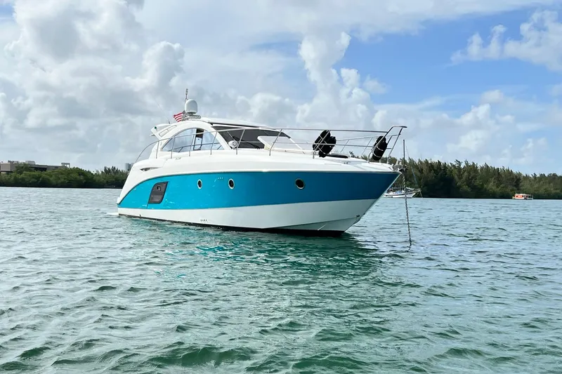 Slide: The Image of 2010 Beneteau Monte Carlo 47 yacht on calm water, showcasing sleek design and luxury features. - 3