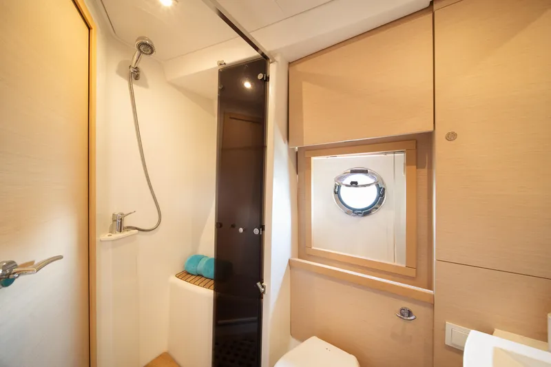 Slide: The Image of Luxurious bathroom in 2010 Beneteau Monte Carlo 47 yacht with shower and porthole window. - 32