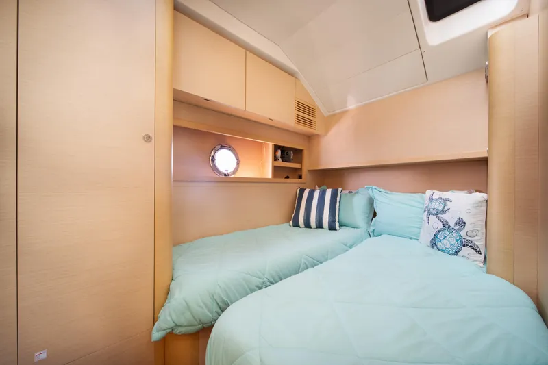 Slide: The Image of Cozy cabin interior of 2010 Beneteau Monte Carlo 47 yacht with twin beds and nautical decor. - 37
