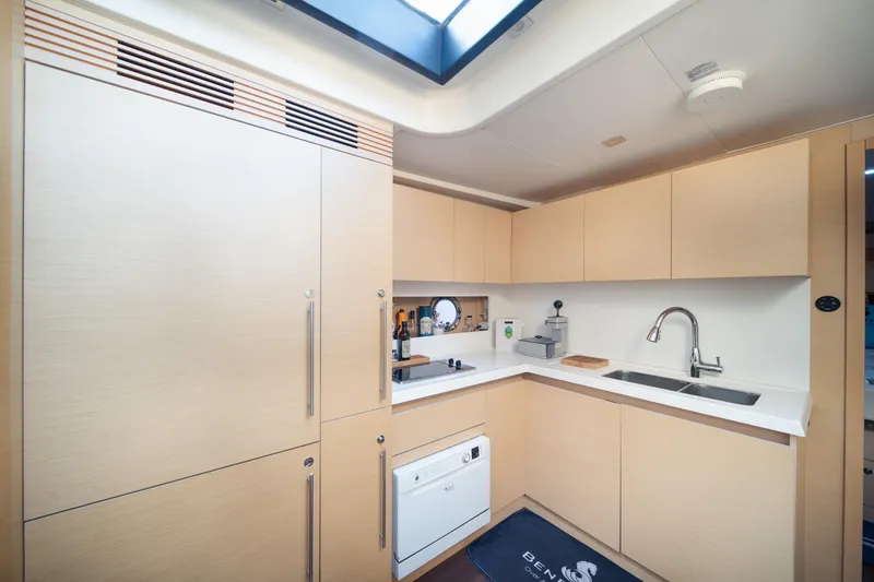 Slide: The Image of Modern kitchen interior on 2010 Beneteau Monte Carlo 47 yacht, featuring sleek cabinetry and appliances. - 38