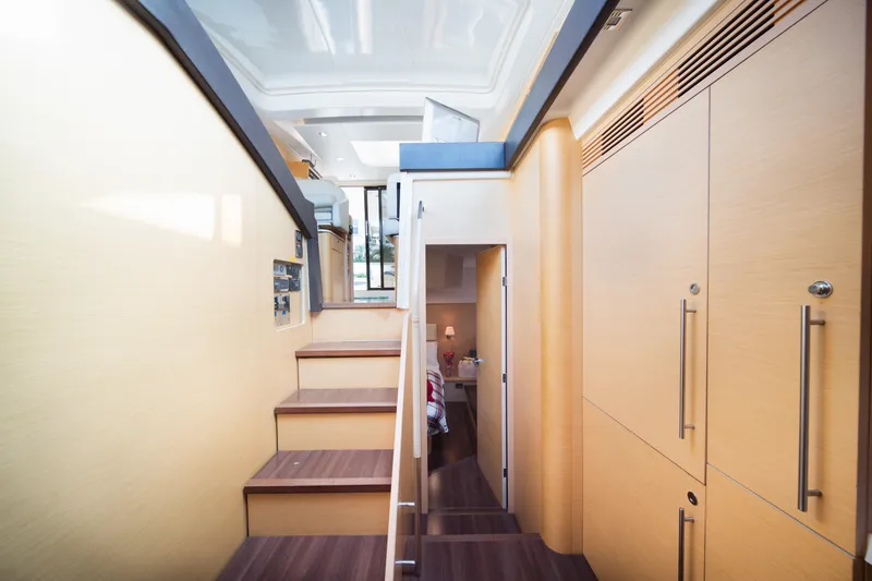 Slide: The Image of Interior of 2010 Beneteau Monte Carlo 47 yacht, featuring modern wooden staircase and cabinetry. - 40
