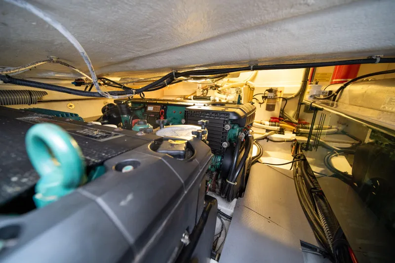 Slide: The Image of Engine room of 2010 Beneteau Monte Carlo 47 yacht, showcasing mechanical components and wiring. - 41