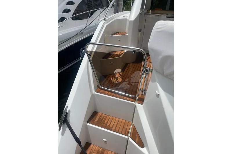 Slide: The Image of 2010 Beneteau Monte Carlo 47 yacht on calm water, showcasing sleek design and spacious deck. - 5