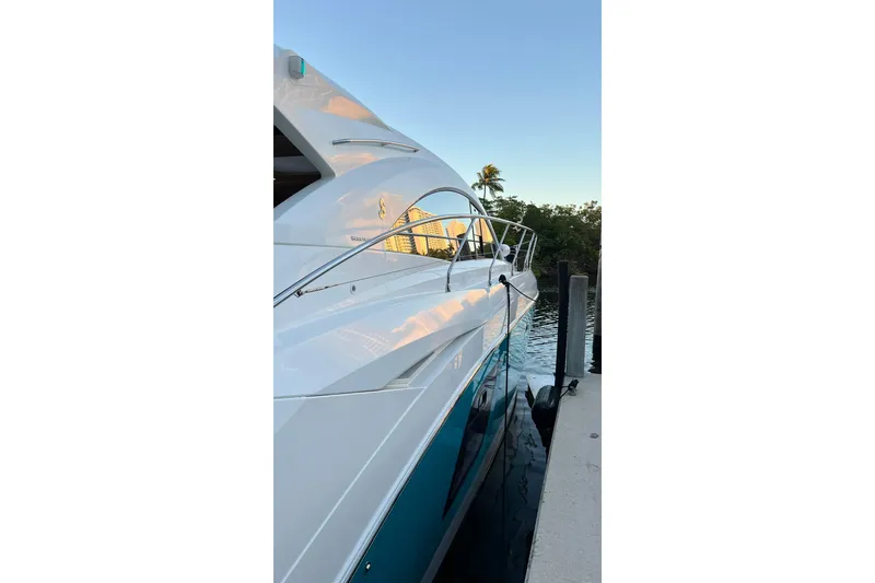 Slide: The Image of 2010 Beneteau Monte Carlo 47 yacht with jet ski on water, clear sky background. - 7