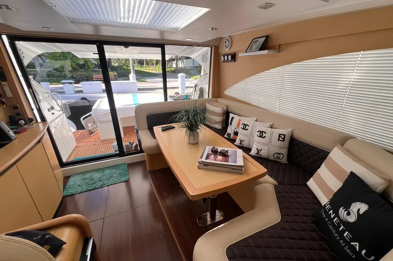 Slide: The Image of Luxurious 2010 Beneteau Monte Carlo 47 yacht deck with seating, overlooking serene waterfront. - 9