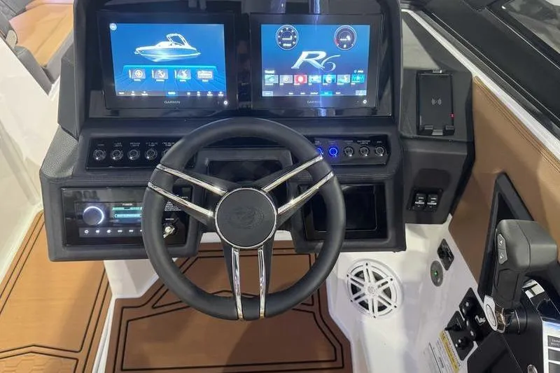 Slide: The Image of 2026 Cobalt R6 Surf boat dashboard with dual touchscreens and modern controls. - 12
