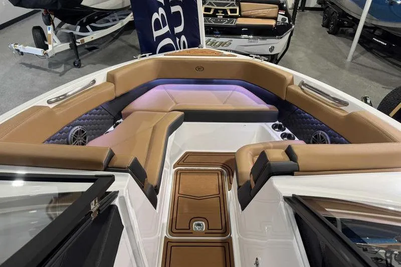 Slide: The Image of 2026 Cobalt R6 Surf boat interior with tan seating and ambient lighting. - 13