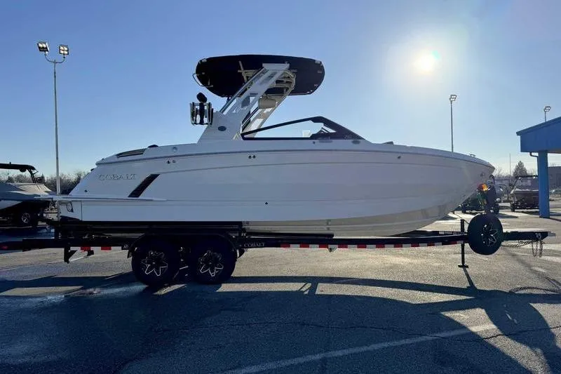 Slide: The Image of 2026 Cobalt R6 Surf boat on trailer under bright sun. - 3