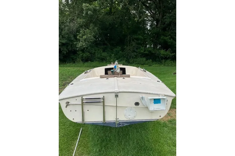 Slide: The Image of 1961 Flying Scot 19 sailboat on grass, surrounded by trees. - 6