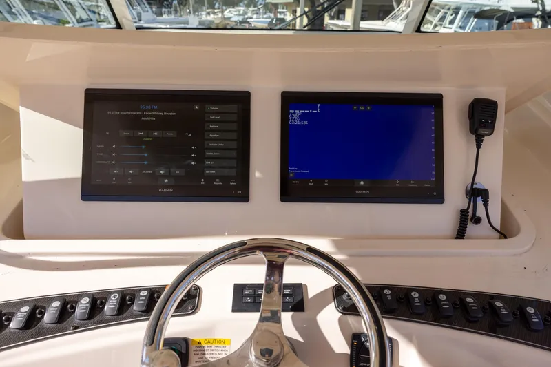 Slide: The Image of 2022 Grady-White Canyon 376 helm with dual Garmin displays and steering wheel. - 12