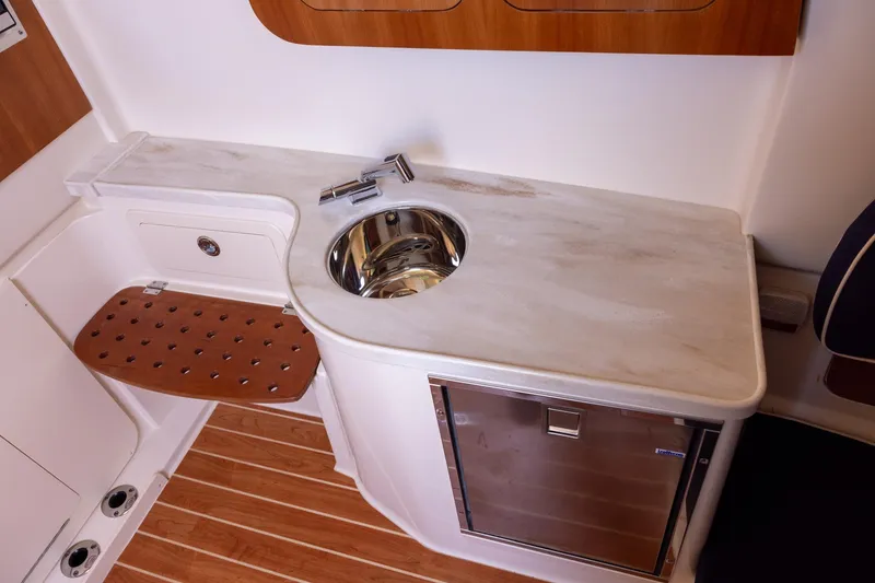 Slide: The Image of 2022 Grady-White Canyon 376 interior with sink, countertop, and mini fridge. - 17