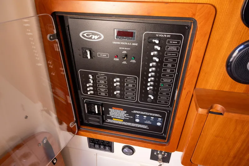 Slide: The Image of Electrical control panel on 2022 Grady-White Canyon 376 boat, featuring switches and circuit breakers. - 19